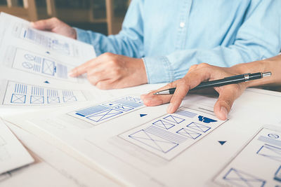 Midsection of man working on table