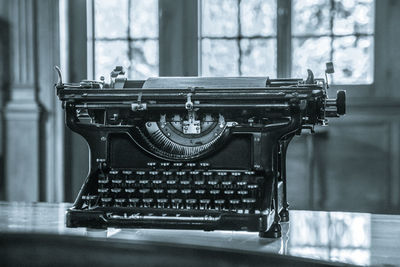 Old-fashioned typewriter on table in office