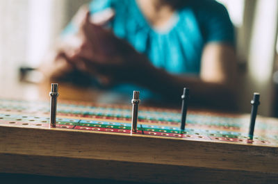 Close-up of woman playing board game on table