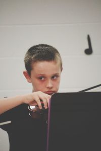 Close-up of boy looking away while playing violin