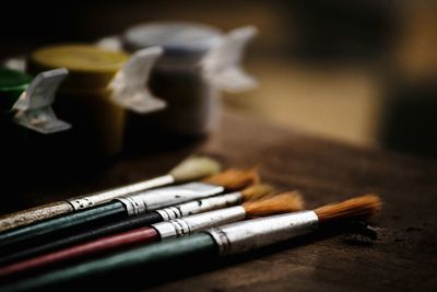 Close-up of paintbrushes on table