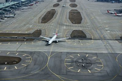 High angle view of airplane on airport runway