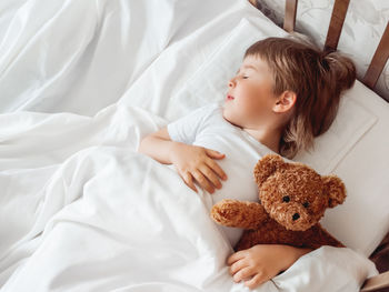 High angle view of baby sleeping on bed at home