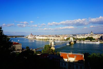 High angle view of cityscape by sea against sky