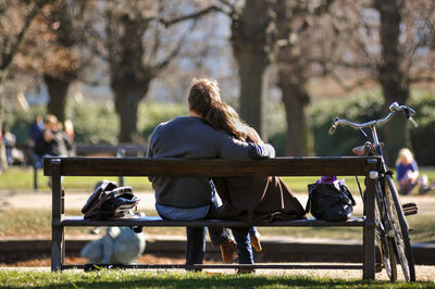 Rear view of couple sitting on grass