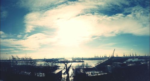 View of harbor against cloudy sky