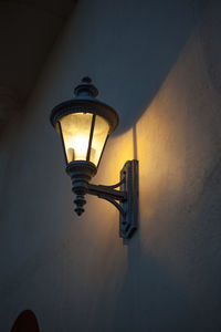 Low angle view of illuminated street light against sky