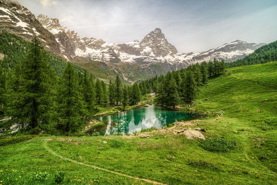 The scenic blue lake surrounded by a beautiful alpine landscape near cervinia,  italy