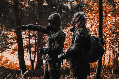 Rear view of women standing in forest