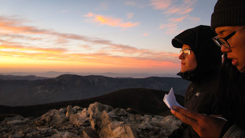 Man photographing at sunset