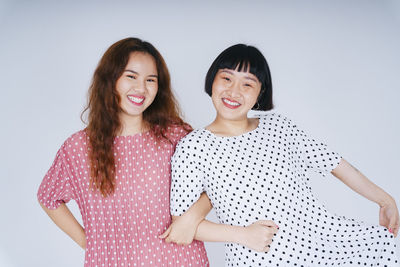 Portrait of lesbian couple against gray background