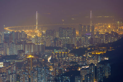 Illuminated cityscape against sky at night