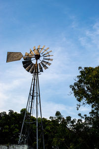 Low angle view of traditional windmill against sky