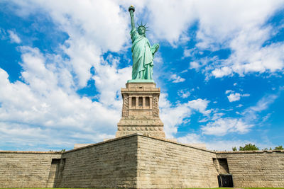 Low angle view of statue against cloudy sky