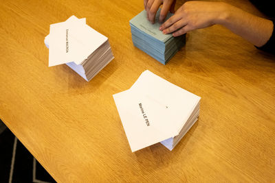 Cropped hand of woman holding toy blocks on table