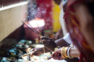 Man and woman doing aarti
