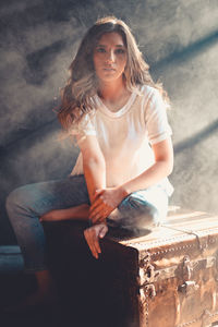 Portrait of a young woman sitting outdoors