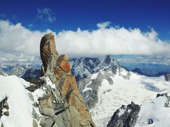 Low angle view of snowcapped mountains against sky