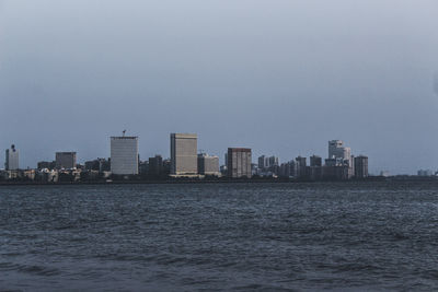 Mumbai city from marine drive, indian ocean in foreground.