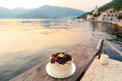 View of ice cream on table by river