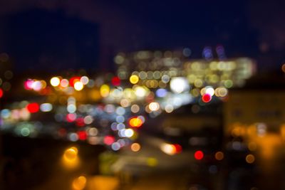 Defocused image of illuminated city at night