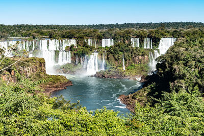 Scenic view of waterfall against clear sky