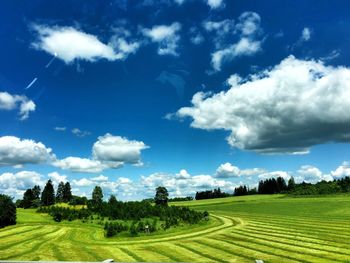 Scenic view of field against cloudy sky