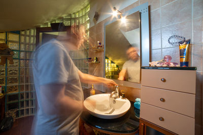 Man and woman standing in bathroom at home