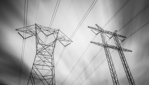 Low angle view of electricity pylon against sky