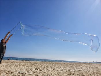 Scenic view of beach against blue sky