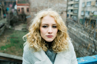 Portrait of young woman standing outdoors