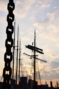 Low angle view of silhouette sailboats against sky at sunset