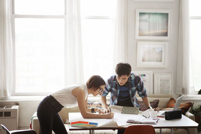 Couple analyzing blueprint at home