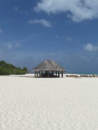 Built structure on beach against sky