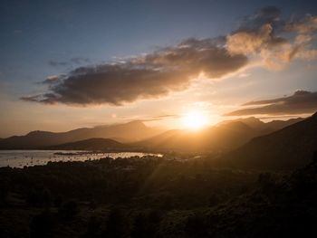 Scenic view of silhouette mountains against sky at sunset