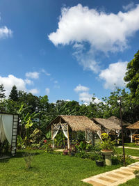Houses on field against sky