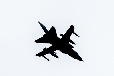 Low angle view of airshow against white background