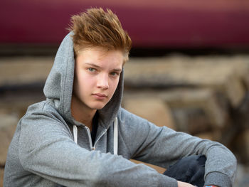 Portrait of young man sitting outdoors