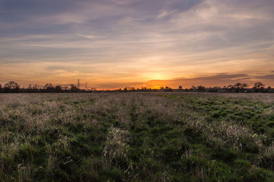 Scenic view of agricultural field against dramatic sky