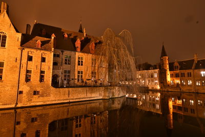 Reflection of illuminated buildings in water at night