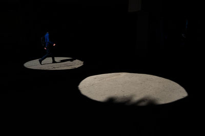 Man with umbrella walking on stage