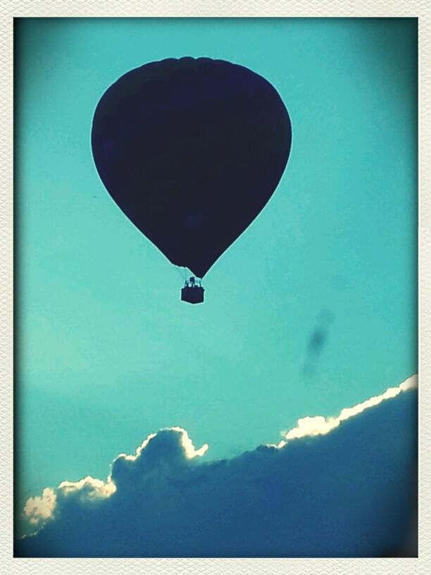 transfer print, blue, low angle view, auto post production filter, sky, flying, mid-air, transportation, outdoors, nature, day, air vehicle, tranquility, no people, copy space, airplane, cloud - sky, lighting equipment, scenics, beauty in nature