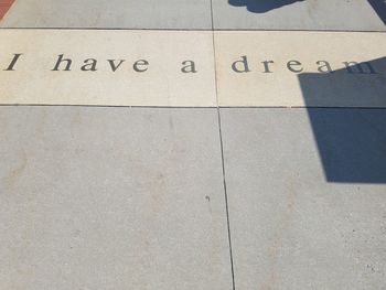 High angle view of text on tiled floor