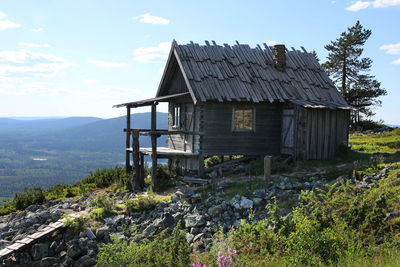 Built structure on landscape against sky