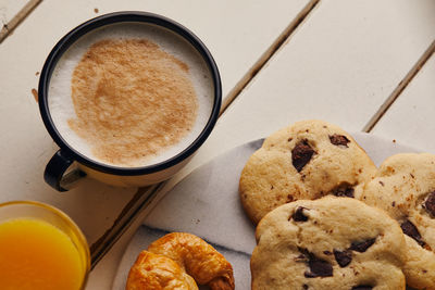High angle view of coffee and cookies on table