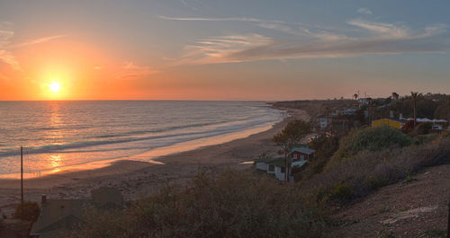 View of calm beach at sunset