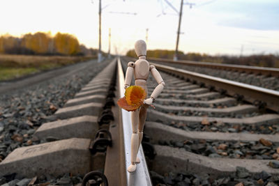 Rear view of man standing on railroad track