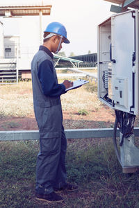 Male engineer checking meter