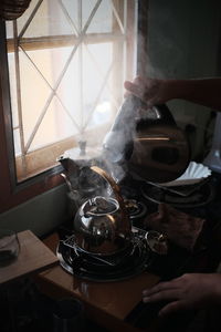 Midsection of person preparing food in kitchen