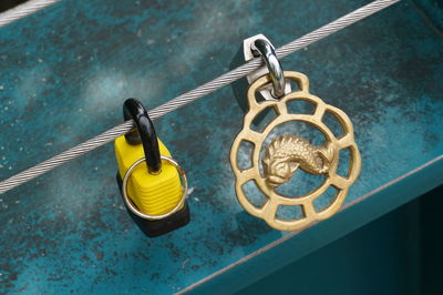 High angle view of padlocks hanging on rope